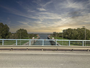 Bridge over road against sky in city