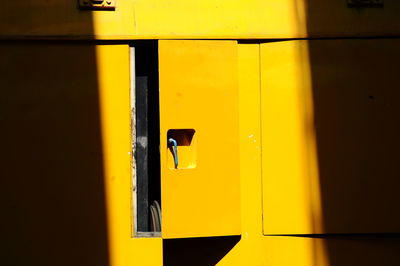 Sunlight falling on open yellow door