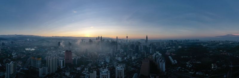 High angle view of modern buildings against sky during sunset