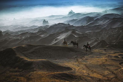 Rear view of man walking on mountain