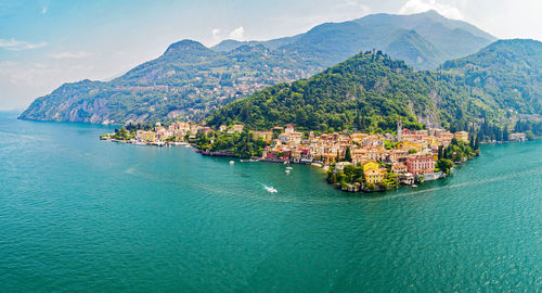 Scenic view of sea by city against sky