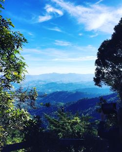 Scenic view of mountains against cloudy sky