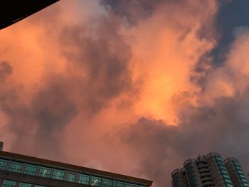 Low angle view of buildings against sky during sunset