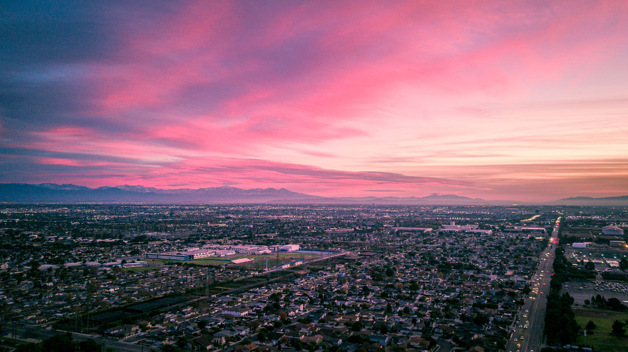 city, cloud - sky, sky, architecture, building exterior, cityscape, sunset, built structure, nature, building, high angle view, no people, residential district, aerial view, scenics - nature, beauty in nature, outdoors, city life, romantic sky