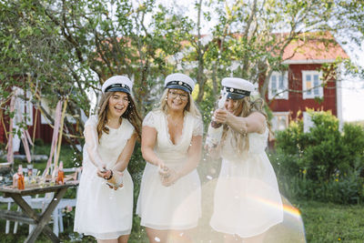 Women celebrating graduation with champagne