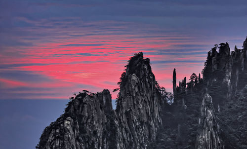 View of rocky mountain against sky during sunset