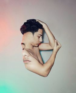 Portrait of shirtless young man against white background