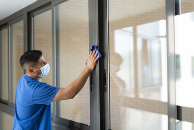 Cleaning staff cleaning the windows to avoid covid19