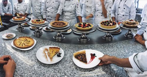 High angle view of people preparing food on table