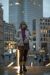 Rear view of woman walking on street in city