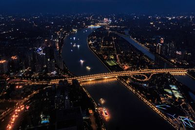 High angle view of illuminated bridge and buildings at night