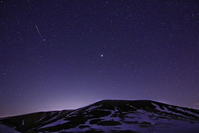 Scenic view of mountains against clear sky at night