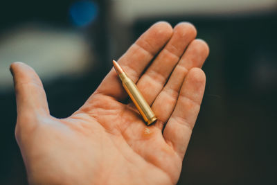 Midsection of person holding cigarette