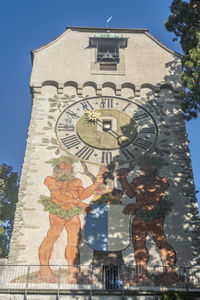 Low angle view of statues on building against sky