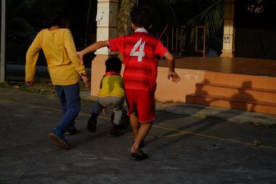 Rear view of people walking on street