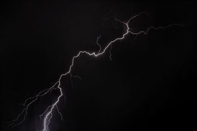 Low angle view of lightning against sky at night