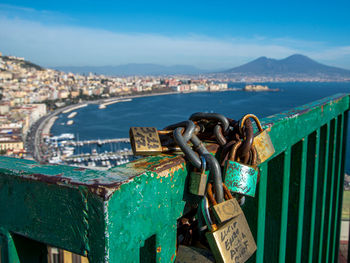 Close-up of padlocks on railing against sea