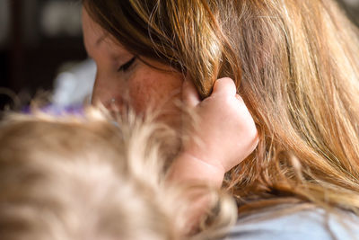 Close-up of woman with daughter at home