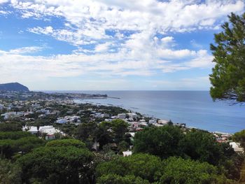 High angle view of townscape by sea against sky