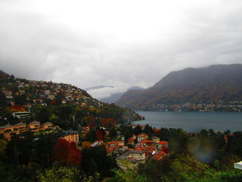 High angle view of townscape by mountain against sky