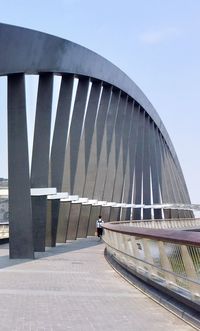 Footpath on bridge against sky