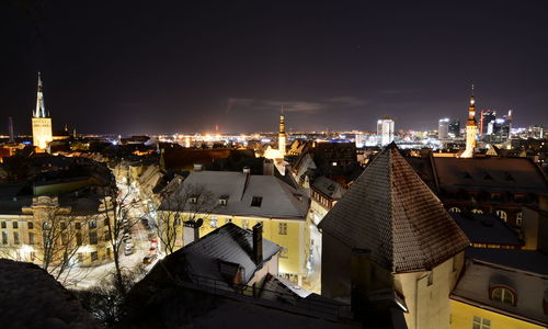 High angle view of illuminated buildings in city at night