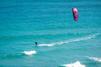 Person paragliding in sea