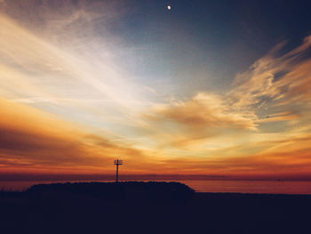 Silhouette landscape against sunset sky