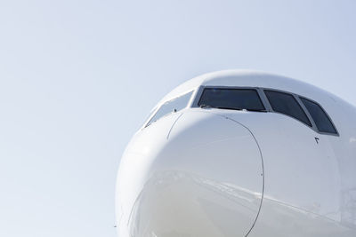 Close-up of airplane against clear sky