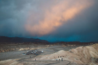 People on desert against sky