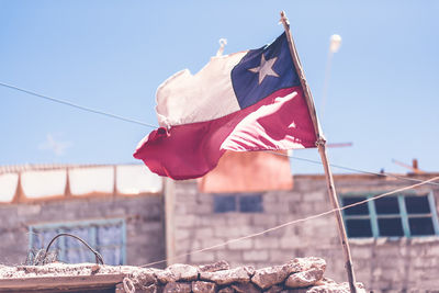 Low angle view of flag against clear sky