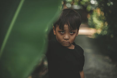 Portrait of cute boy standing outdoors