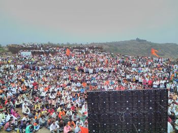 Crowd watching celebration on screen during festival