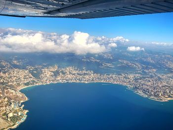 Aerial view of sea and buildings against sky