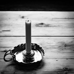 High angle view of candle on wooden table