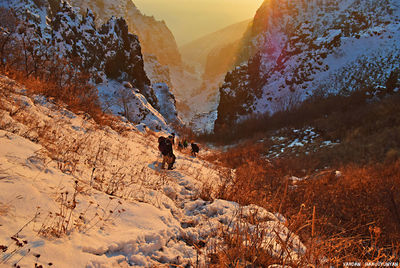 People on mountain against sky