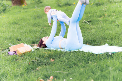Side view of woman lying on grass