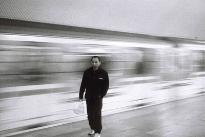 Full length of man standing on railroad station platform