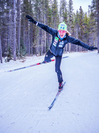 Full length of smiling woman on snow