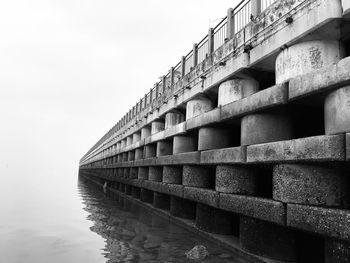 Low angle view of bridge over river against clear sky