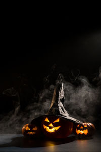 Illuminated pumpkin against black background