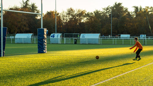 Boy playing soccer on playground