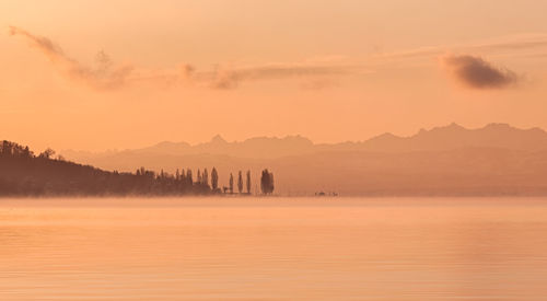 Scenic view of lake against sky during sunset