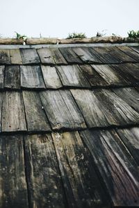 Close-up of roof tiles against sky