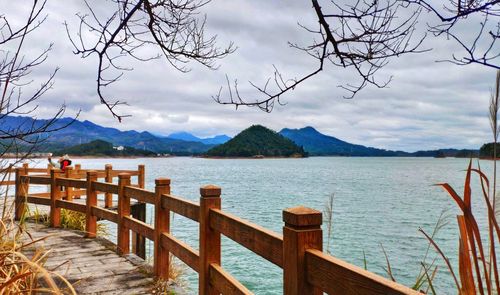 Pier over lake against sky