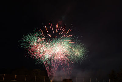 Low angle view of firework display at night