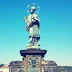 Low angle view of statue against clear blue sky