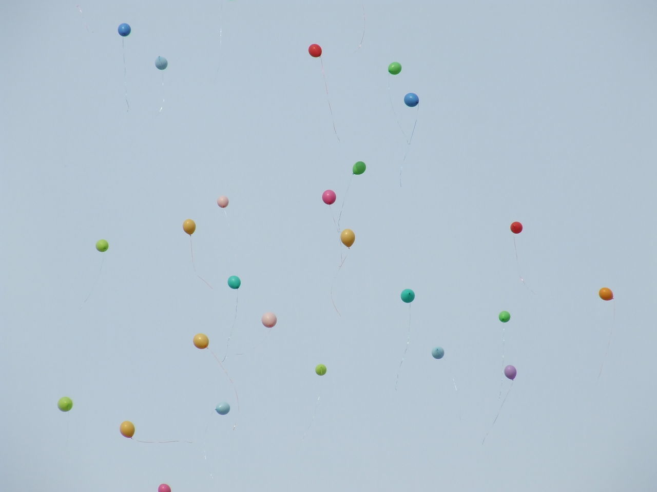 LOW ANGLE VIEW OF BALLOONS AGAINST SKY OVER WHITE BACKGROUND