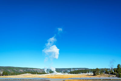 Scenic view of landscape against blue sky