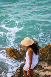 Rear view of woman standing in sea